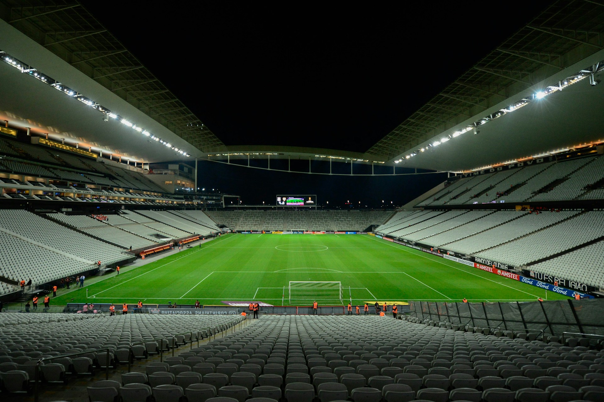 An empty football stadium under floodlights